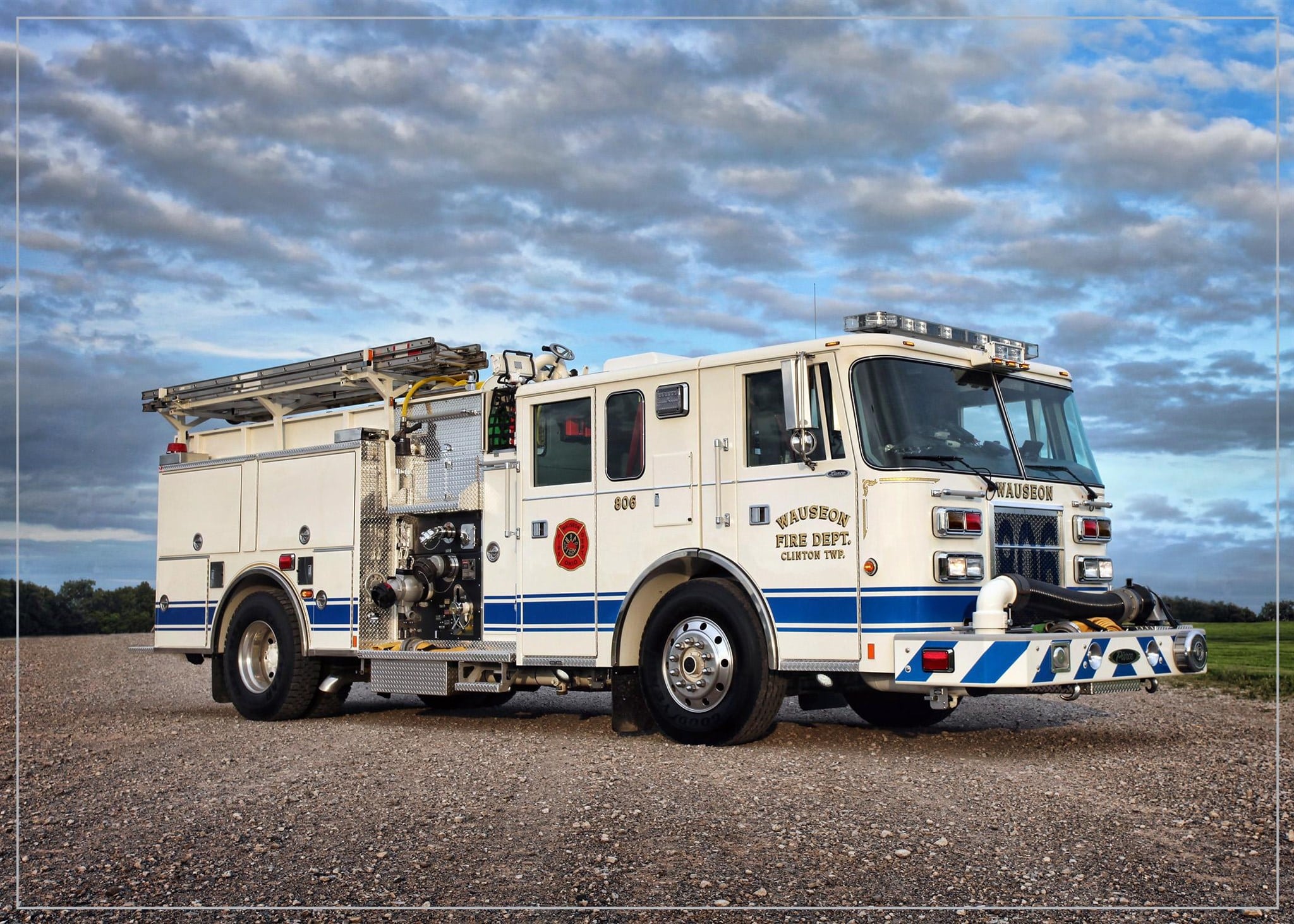 Engine 806 parked in the gravel on a cloudy day