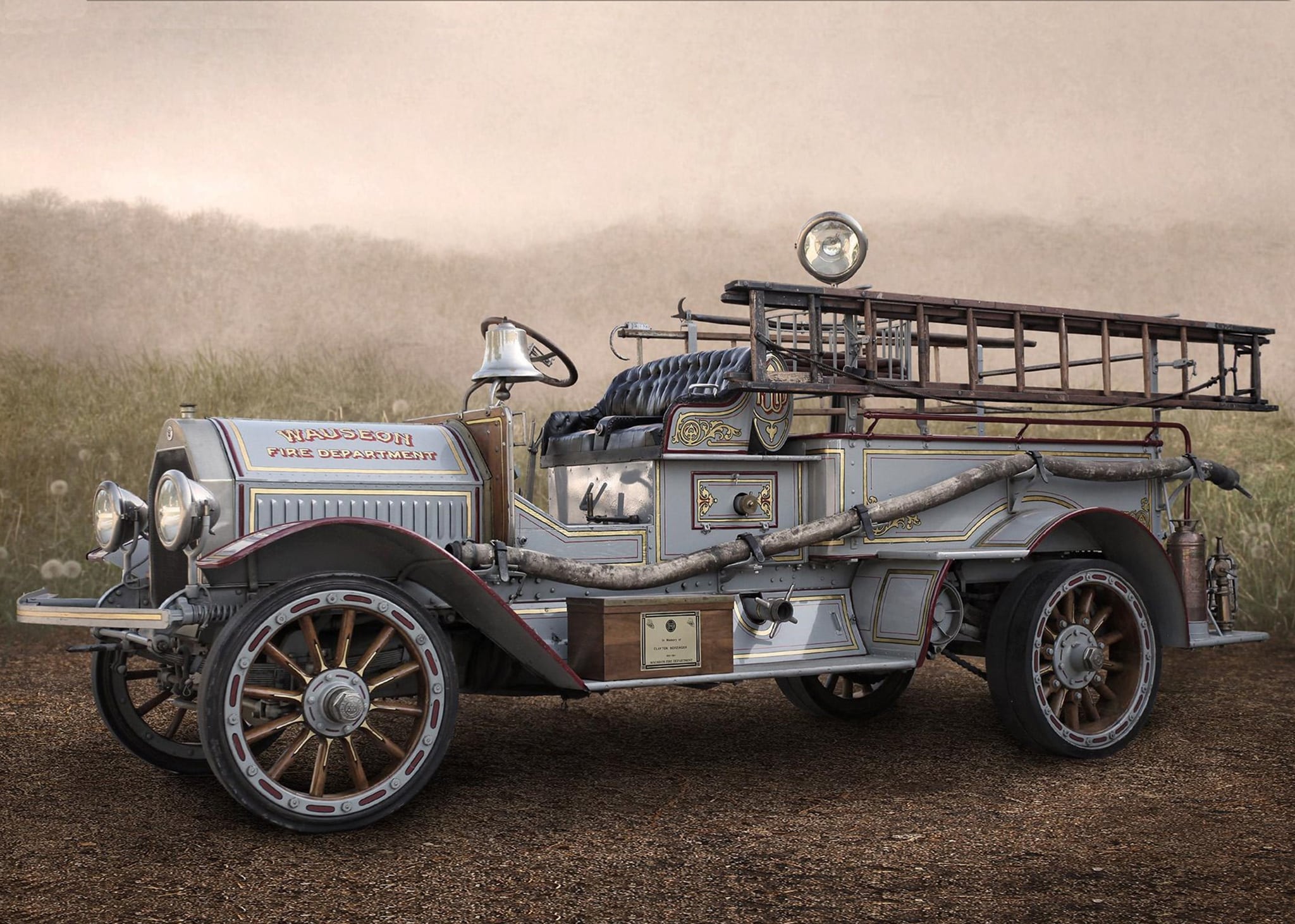 Antique 1916 Seagrave pumper parked in a field