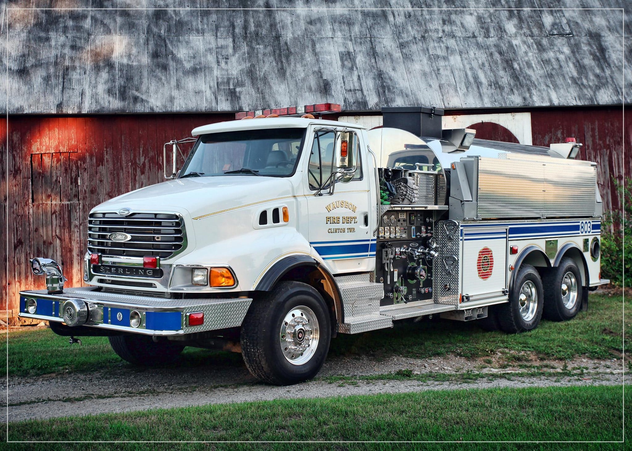 Tanker 803 parked in front of a red barn